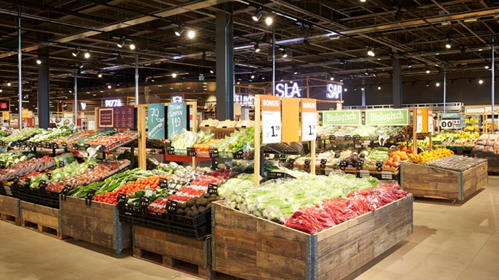 A well-stocked fresh fruit and vegetables section of an Albert Heijn supermarket. - smart retail lighting