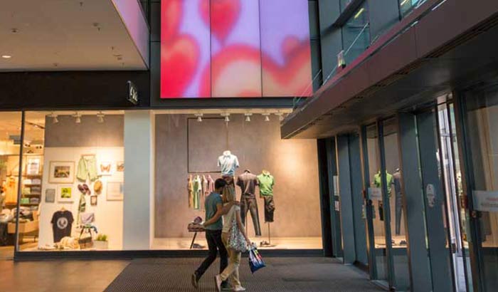 A couple gazes at an ever-changing Luminous Textile panel in Centrum Galerie shopping mall